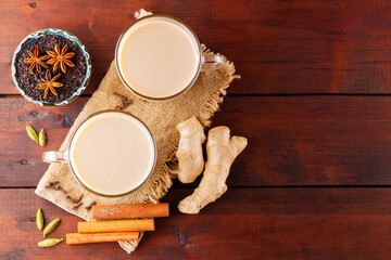 Masala chai tea on burlap. Traditional indian drink - masala tea with spices on a wooden background. Copy space. Top view