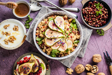 top view of gourmet dish with Figs fruits, nuts, honey, couscous and pomegranate seeds on table