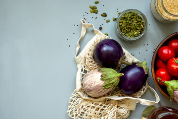Healthy food vegetables on grey background. Groceries in recycle textile bags. Eco friendly plastic free low waste lifestyle. Zero waste bio food storage and shopping concept Banner copy space