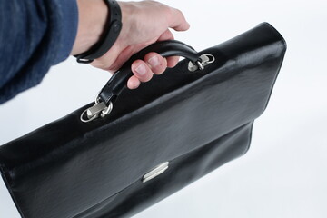 Hand holding a briefcase on a white background