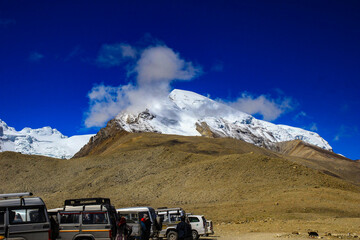Lachen, Sikkim, June 2018, Tourists in front of parked cars near mountain range of Gurudongmar lake at Sikkim, India.