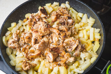 Mushrooms chanterelle fried with potatoes in a frying pan