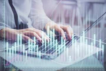 Multi exposure of woman hands typing on computer and financial graph hologram drawing. Stock market analysis concept.