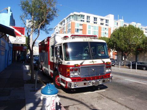SFFD Red Firetruck parked on 4th street with sun reflecting in the window