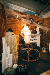 Halloween decorations. Photo area for Halloween in the interior with a fireplace and a rocking chair. Background.Copy space. Vertical