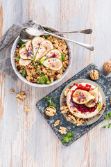 top view of gourmet dish with Figs fruits, nuts, honey, couscous and pomegranate seeds on table