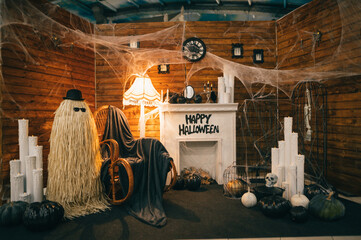 Photo area for Halloween with a fireplace, a chair and objects with Halloween symbols. Halloween...