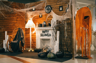 Photo area for Halloween with festive attributes. Fireplace, pumpkins, candles, skulls, bones,...