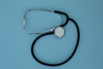 Black stethoscope depicted on a blue background
