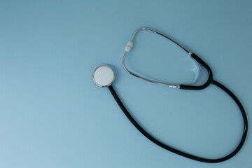 Black stethoscope depicted on a blue background