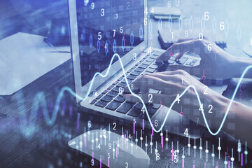 Double exposure of woman hands typing on computer and forex chart hologram drawing. Stock market invest concept.