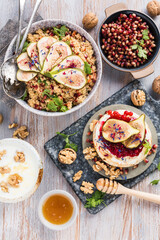 top view of gourmet dish with Figs fruits, nuts, honey, couscous and pomegranate seeds on table