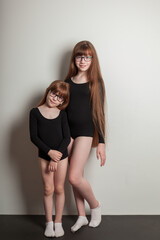 portrait of happy girls in a sports gymnastic swimsuit