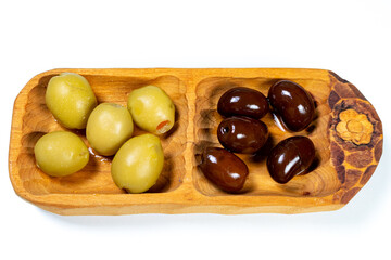 Black and green olives in a small wooden bowl on a white surface background