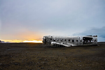 Plane wreck at sunrise on a black sand beach in Iceland