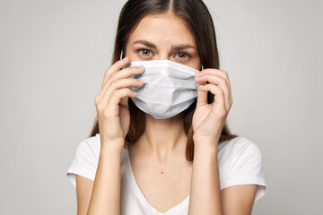 Woman in medical mask on face Look Forward white T-shirt 