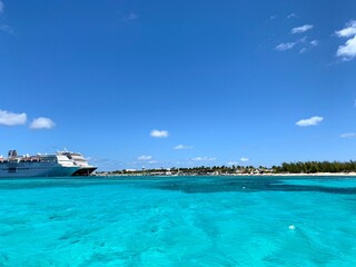 bright blue and green ocean with bright white clouds 