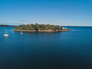 Aerial Drone image of the Curtis Island Lighthouse att he entrance to Camden Harbor on Penobscot...