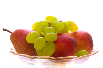 Fruit in glass vase on white isolated background
