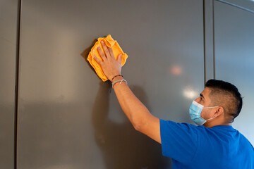 maintenance staff disinfecting hotel walls - obrazy, fototapety, plakaty