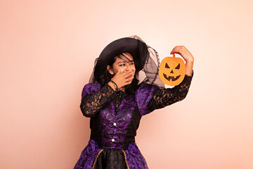 A woman dressed in a witch costume posing