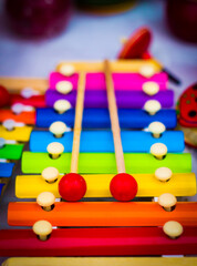 colourful rainbow coloured wooden xylophone shot in shallow depth if field