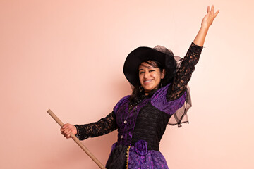 A woman dressed in a witch costume posing