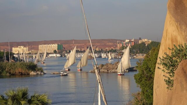 Beautiful landscape with felucca boats on Nile river in Aswan at sunset, Egypt, 4k