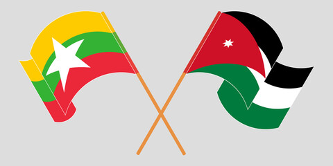 Crossed and waving flags of Myanmar and Jordan