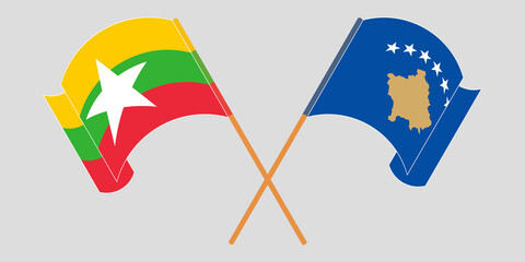 Crossed and waving flags of Myanmar and Kosovo