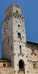 Fototapeta na wymiar Cortesi Palace and the devils tower in Piazza della Cisterna San Gimignano