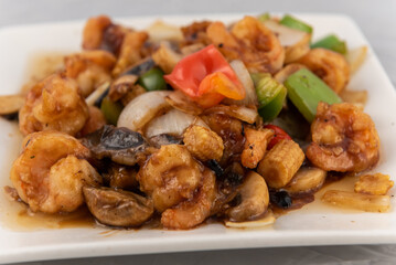 Detail view of appetizing plate tempting the tastebuds with shrimp in black bean sauce in perfect serving size.
