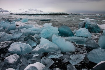 Icebergs washed up on black sand beach called Diamond Beach on the south coast of Iceland near Jökulsárlón glacier lagoon