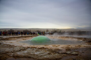 Volcanic geothermal geyser about to erupt water in Iceland