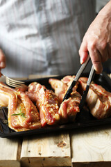 Marinated pork ribs on a pan. The chef marinates pork ribs. Barbecuing ribs.