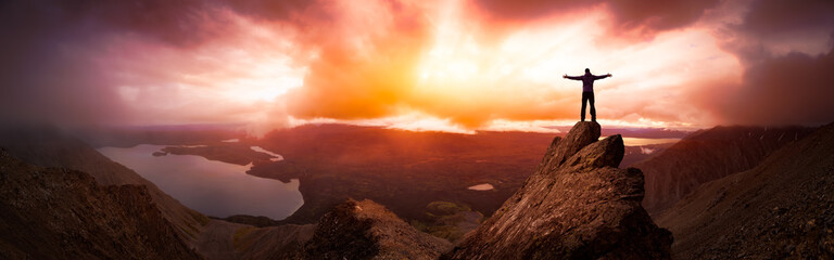 Magical Fantasy Adventure Composite of Man Hiking on top of a rocky mountain peak. Background...