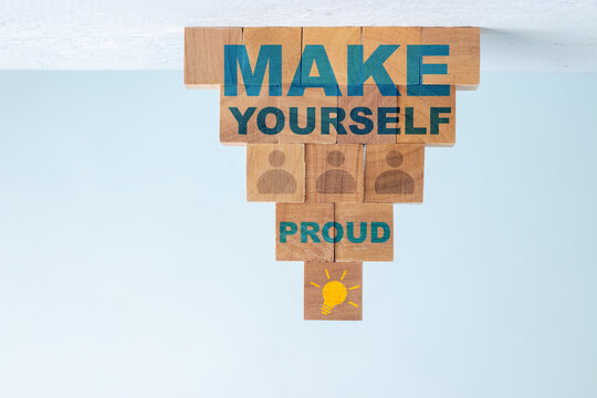 Inspiration quotes " MAKE YOURSELF PROUD" on wooden block