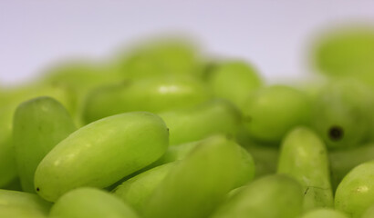 Green grape without branches and leaves isolated on white. With clipping path. Close up macro and shallow depth of field.