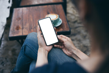 cell phone mockup blank white screen.woman hand holding texting using mobile on desk at coffee shop.background empty space for advertise.work people contact marketing business,technology