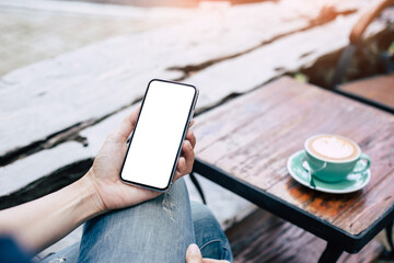 cell phone mockup blank white screen.woman hand holding texting using mobile on desk at coffee shop.background empty space for advertise.work people contact marketing business,technology
