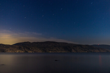 starry sky seen from the shore of Okanagan lake at night british columbia Canada