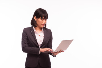 Asian woman working laptop Business women are busy working on laptop computers at the studio. The background is white