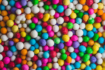 Fototapeta na wymiar Macro close up portrait of colorful candy sprinkles , studio lighting, selective focus
