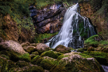 Fototapeta na wymiar Waterfall in forest with rocks