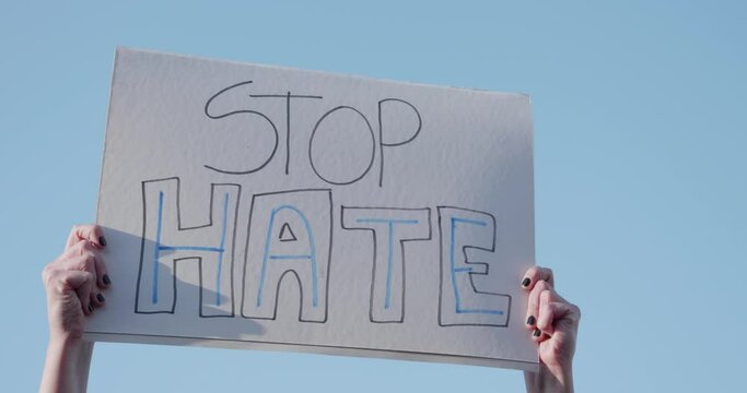 Woman Holding A Stop Hate Sign 