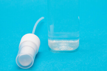Close up image of transparent mist spray bottle lid on a blue background