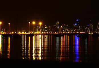 Fototapeta na wymiar The Melbourne city skyline at night with lights on Port Phillip Bay