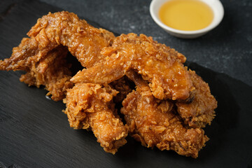 fried chicken in honey on a black background
