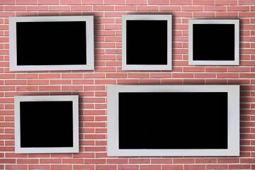 White picture frames arranged in a pattern on the wall. There is space for images or advertising materials.