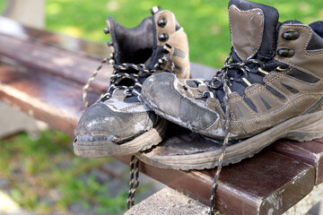 Broken hiking boots after the hike on the bench